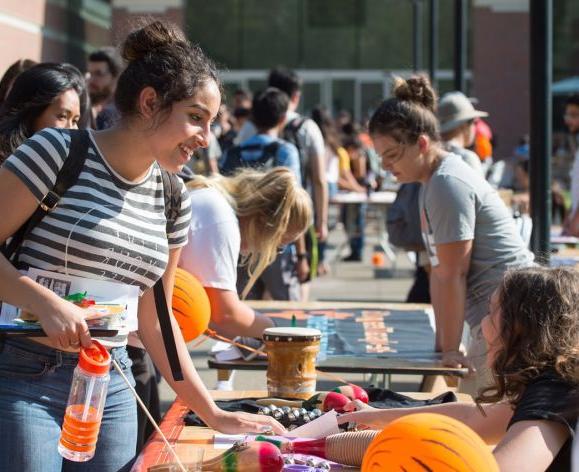 Undergraduate students at a club fair in front of the DeRosa University Center